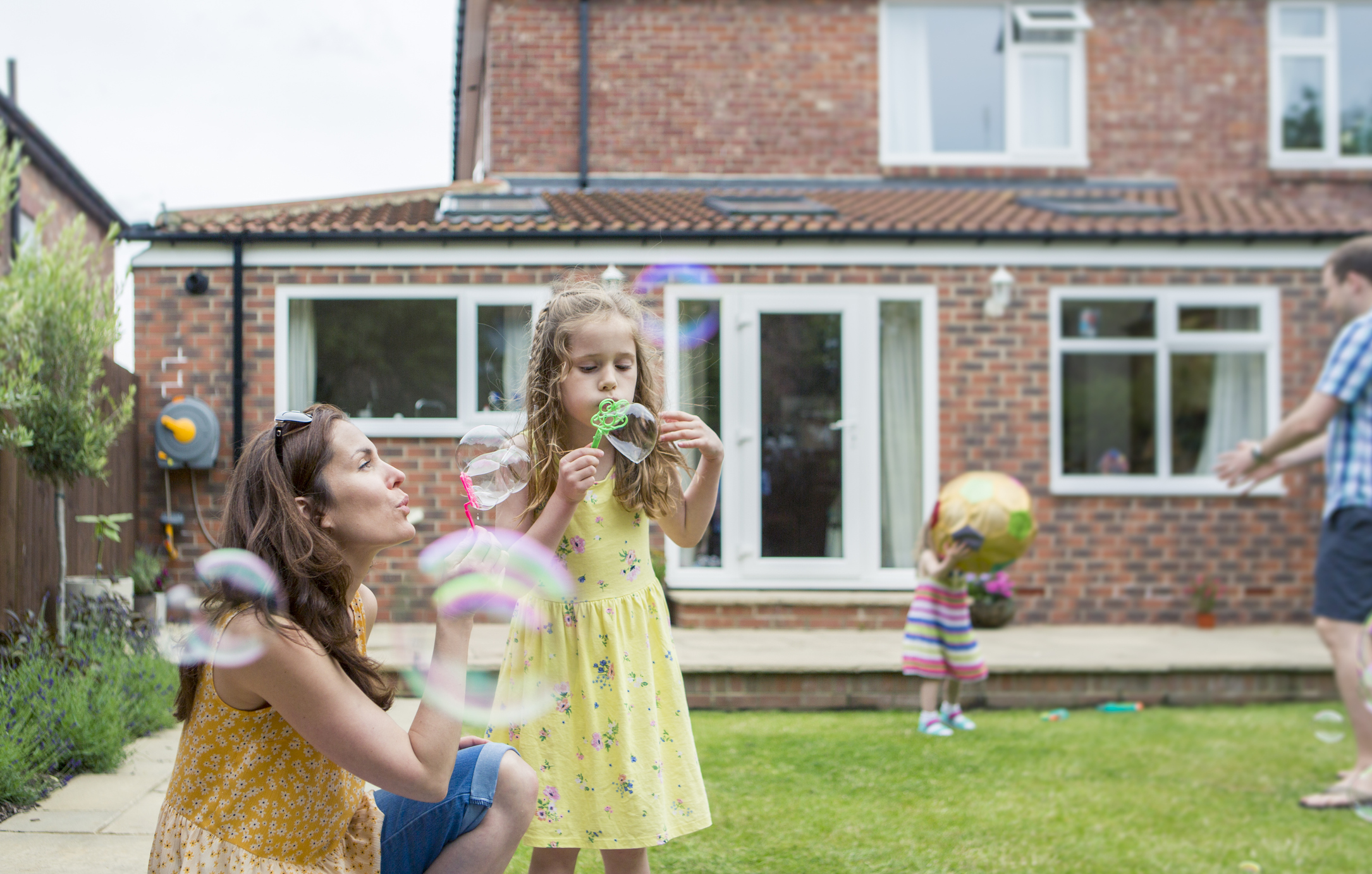 Mother and Daughter Blowing Bubbles